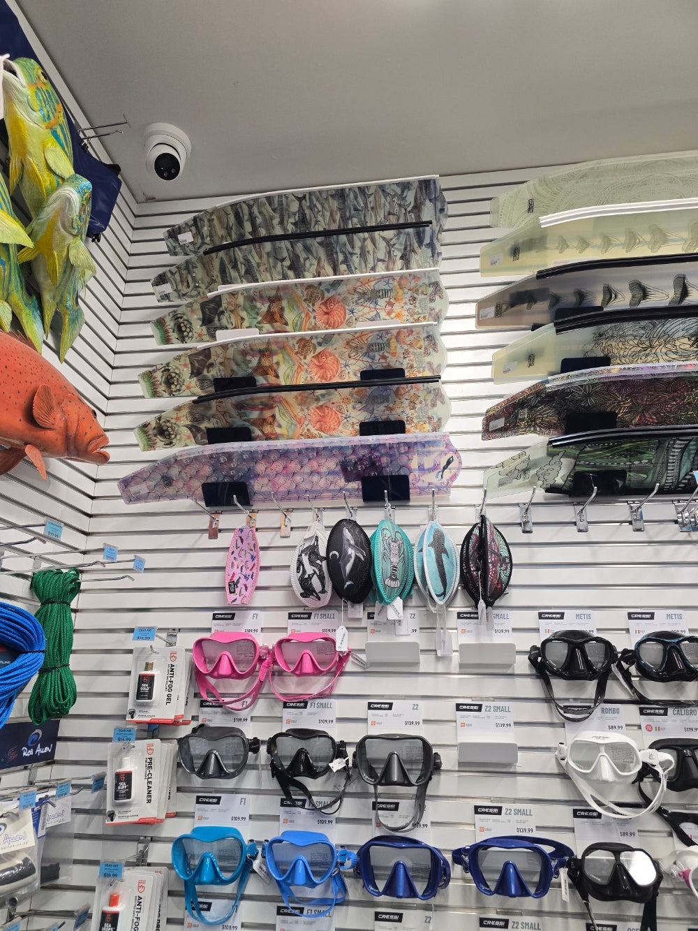 Display of various Divermon Art freediving fins and mask tamers on a wall rack in a store at Exmouth Tackleworld
