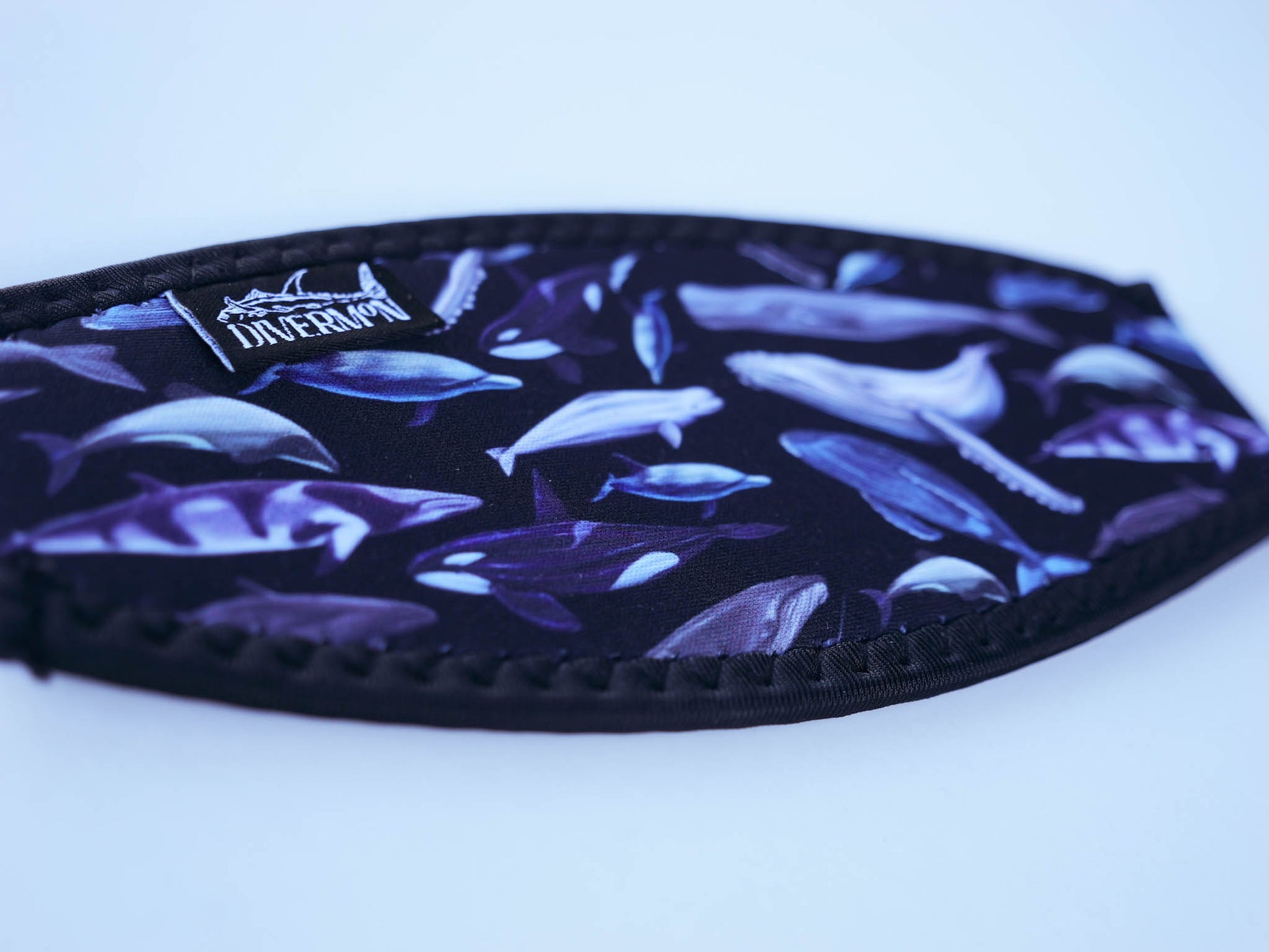 Dolphins, whales and porpoises with a black background neoprene mask strap tamer shown in detail close up ocean illustration by Diver Mon Art