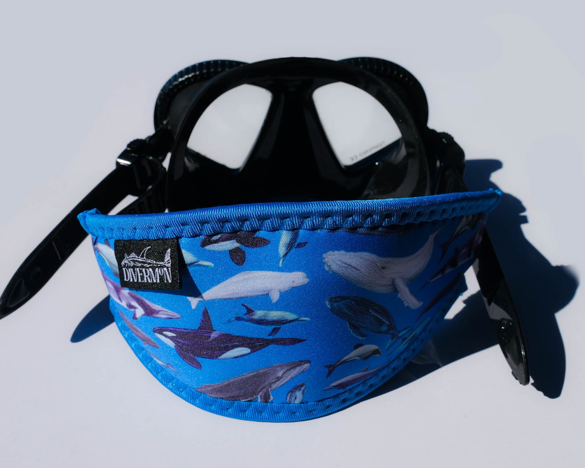 Cetacean Blue neoprene mask tamer with whale and dolphin design by Diver Mon Art shown with mask 