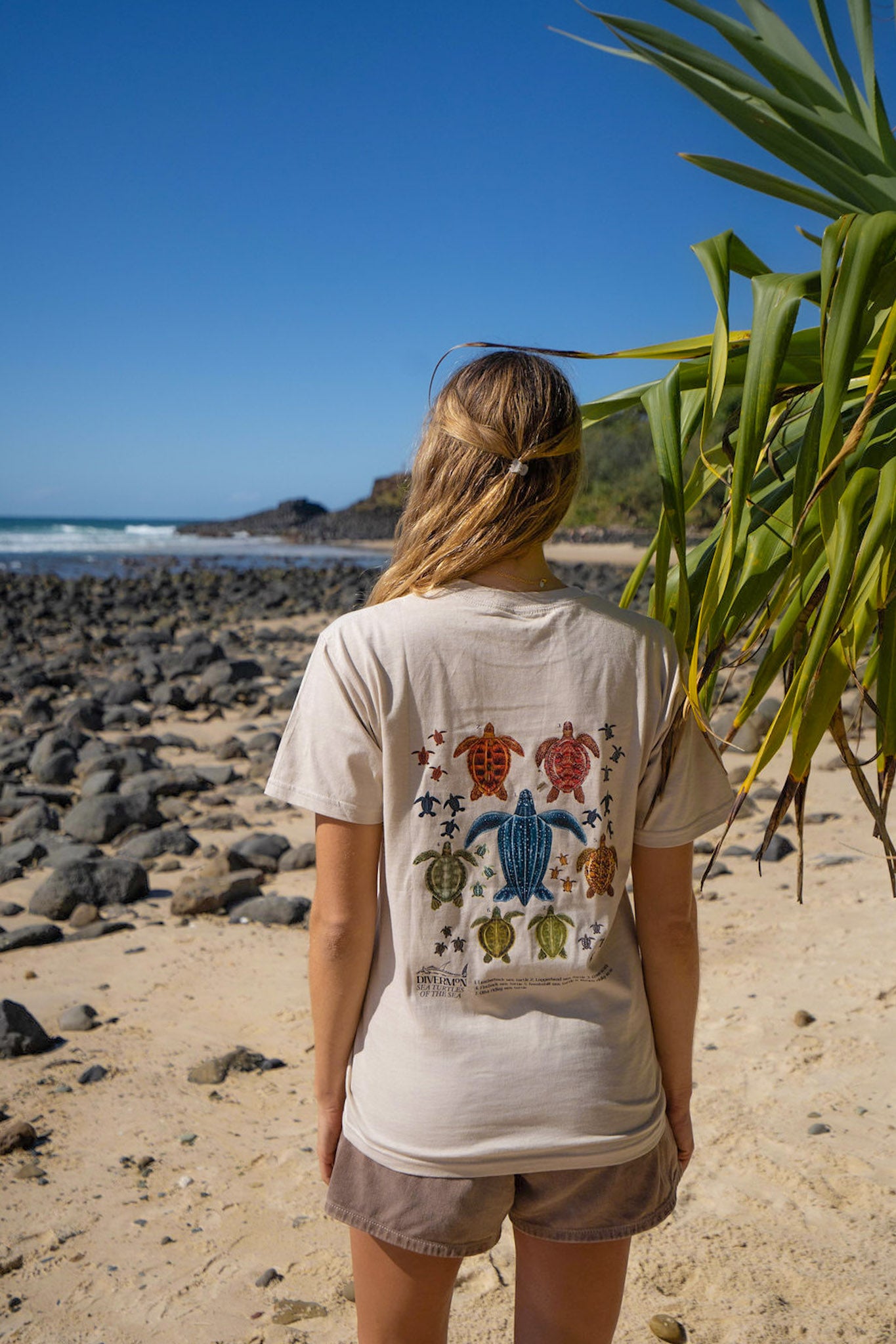 Front of tan Diver Mon Art turtle artwork t shirt featuring small turtle and Diver Mon Art logo