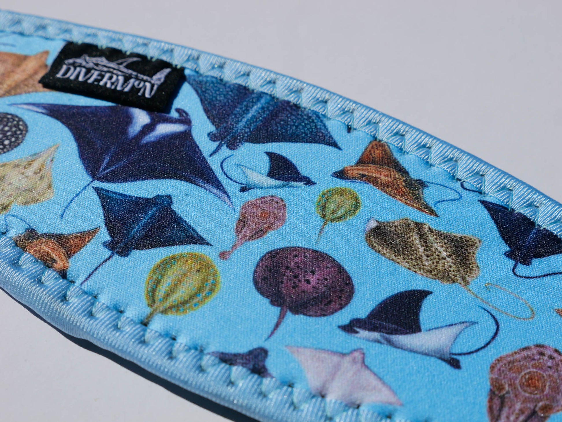 Sting Ray and Manta ray design with a light blue background neoprene mask strap tamer ocean illustration by Diver Mon Art dive hair accessories
