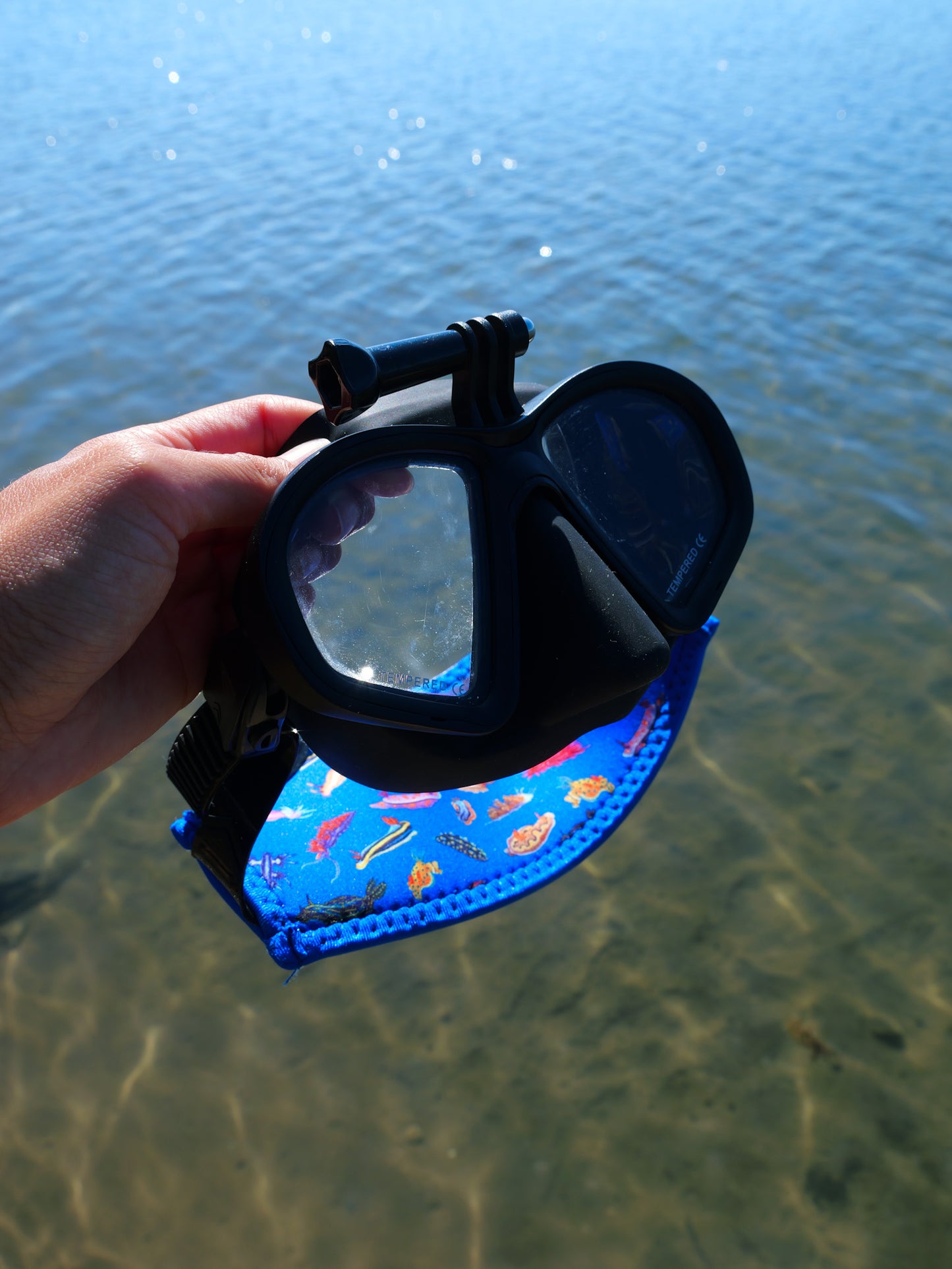 Nudibranch dark blue neoprene mask tamer on a clear water background shown close up in great detail fitted to mask ocean illustration by Diver Mon Art 
