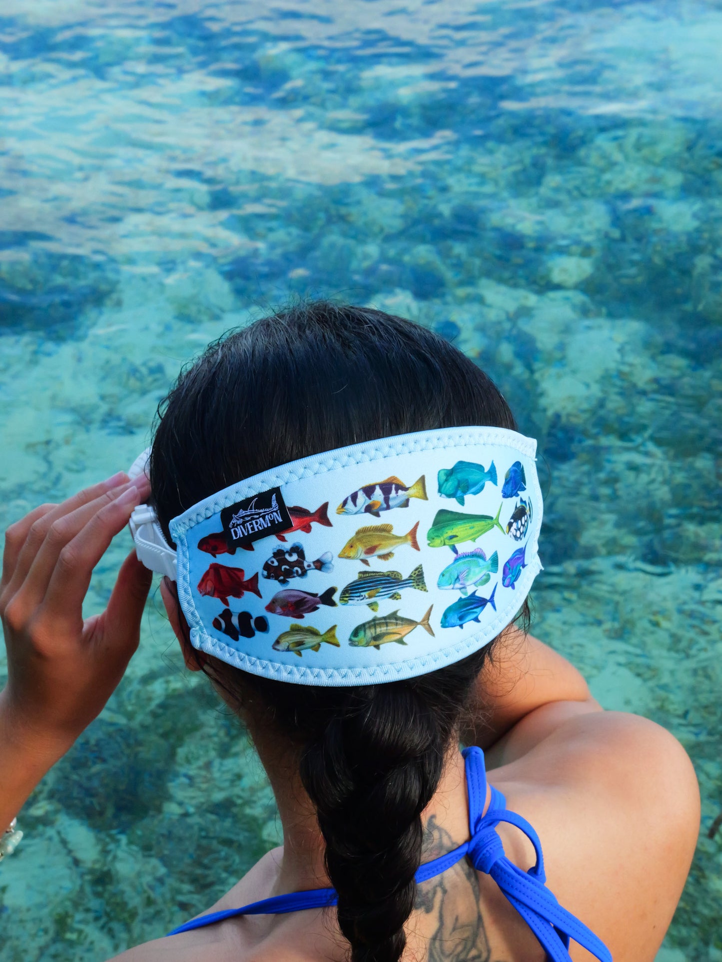 Dark haired woman shown from behind in blue clear water close up in great detail rainbow fish blue design neoprene mask strap tamer ocean illustration by Diver Mon Art