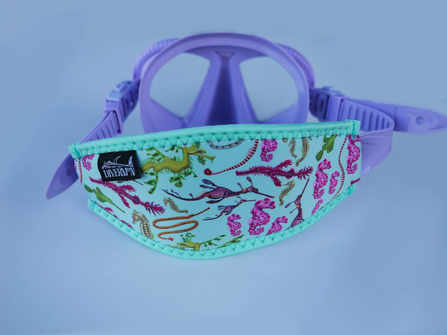 Seahorse green neoprene mask tamer close up in great detail by Diver Mon Art shown with fitted to purple mask 