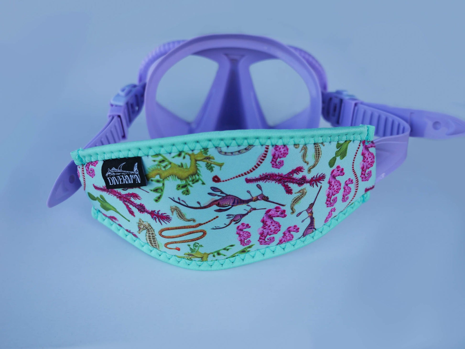 Seahorse green neoprene mask tamer close up in great detail by Diver Mon Art shown with fitted to purple mask 