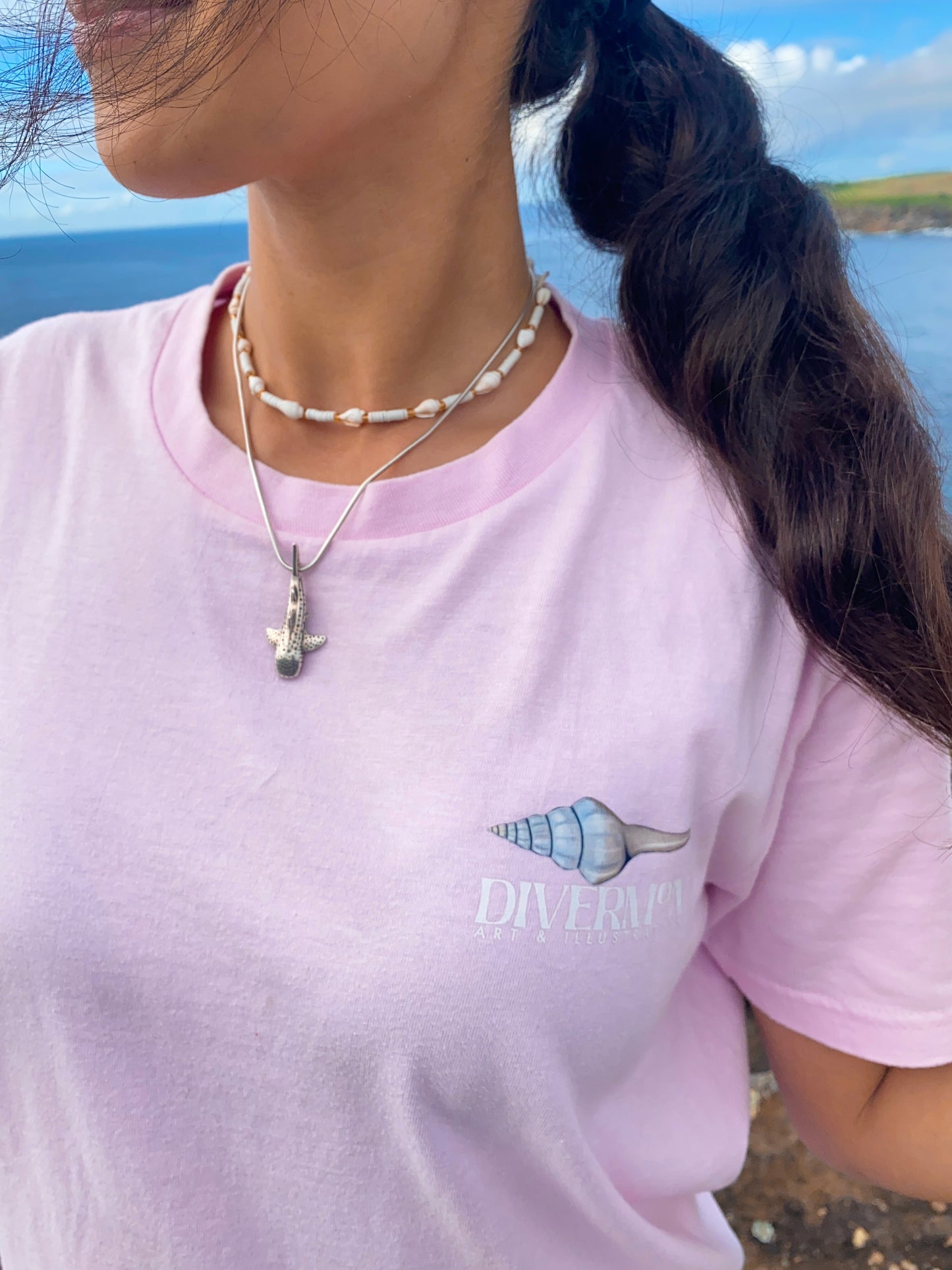 Front Logo Pink seashell t shirt featuring ocean shell artwork by Diver Mon Art marine life illustration for beach and coastal style