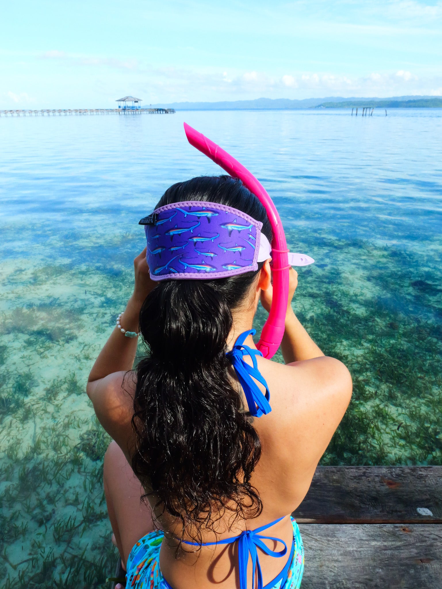 Dark haired woman seen from behind in clear blue water thresher design with purple background neoprene mask strap tamer ocean illustration by Diver Mon Art 